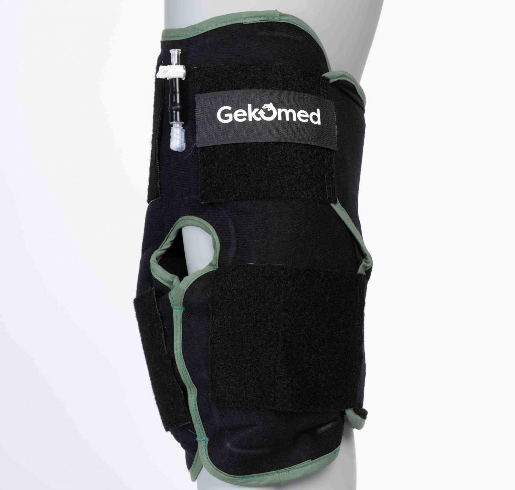 Attelle de genou GekoFrost Gekomed avec système de cryothérapie compressive et pompe manuelle pour traitement post-opératoire.